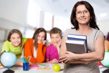 Teacher and group student in classroom.