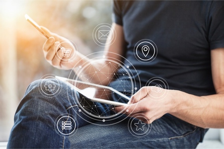 Man with phone and digital tablet.
