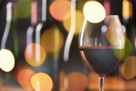 Red wine glass on bokeh backgroundの写真素材
