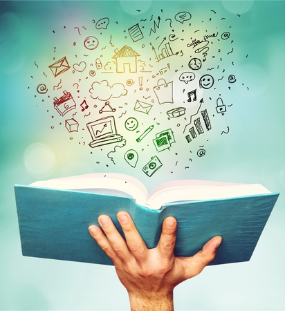 education and book concept - close up hand holding open book with magic lightsの写真素材