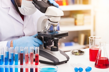 Men in a laboratory microscope.の写真素材