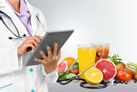 Doctor with digital tablet and food.の写真素材