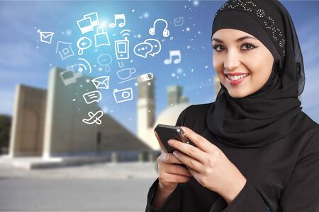 Arabic woman using smartphone.