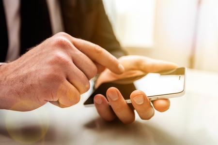 Business man hand working on phone.の写真素材