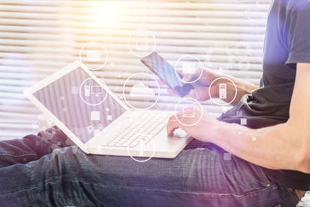 Man work on tablet and phone.