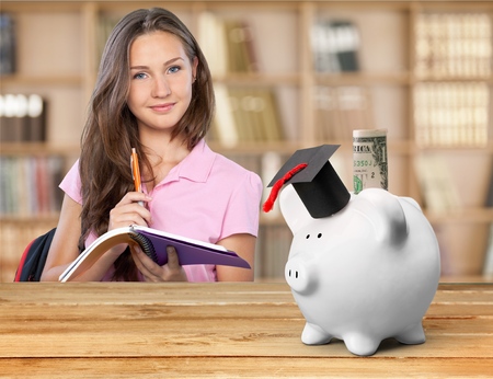 Piggy Bank with Mortarboard and Banknoteの写真素材