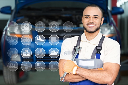 Smiling Mechanic Holding a Wrenchの写真素材