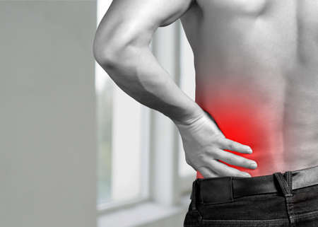 Backache. Pain in the lower back. Mans back