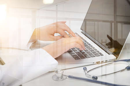 Closeup of Doctor Typing on Laptopの写真素材