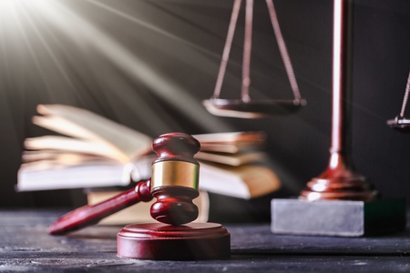 Justice Scales and books and gavel on wooden table