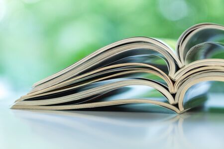 Stack of magazines open page on tableの写真素材