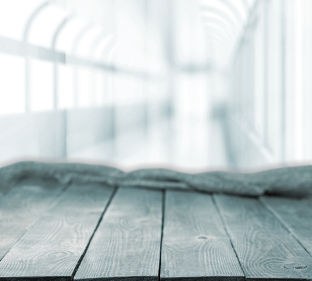 Wooden table on defocuced window with curtain background