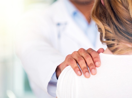 Smiling patient in the doctors office, she is receiving a prescription medicineの写真素材