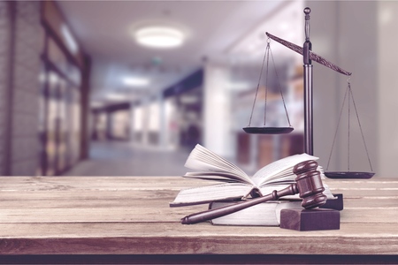 scales of justice on law books in a courtroom or law firm. concept of law,legal education.の写真素材