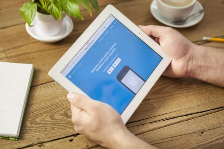 KHERSON, UKRAINE - FEBRUARY 19 :man with wordpress on tablet pc in the hands on backgroundのeditorial素材