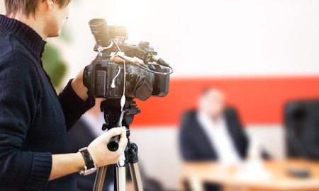 Behind the scenes of movie shooting or video production and film crew team with camera equipment at outdoor location.の写真素材