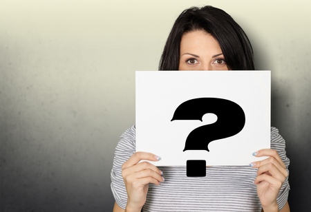 Girl holding a signboard with a question mark