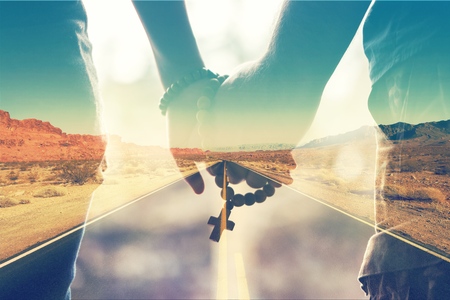 Mother and son praying together. Holding rosary in hand.の写真素材