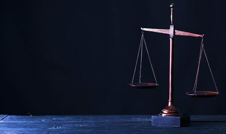 Retro law scales on table. Symbol of justice. Vintage style sepia photoの写真素材