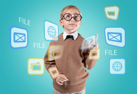 Portrait of male elementary school student with lightbulb picture on blackboardの写真素材