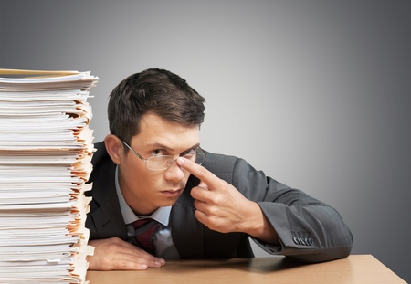 Man Surrounded by File Foldersの写真素材