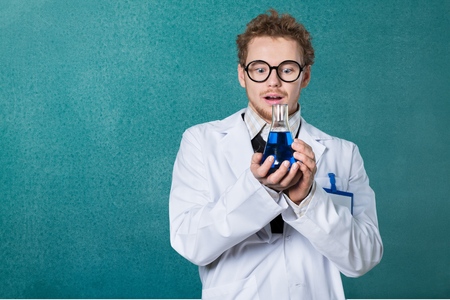 Crazy chemist woman with disheveled hair and vial in hands