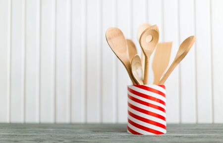 Utensils in metal containers isolated on light backgroundの写真素材