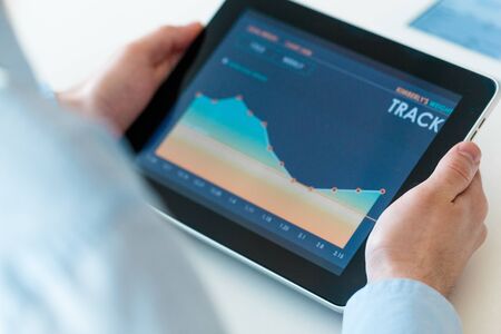 Businessman checking stock market on tablet
