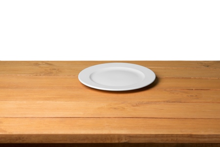 Empty plate on wooden table over nature backgroundの写真素材