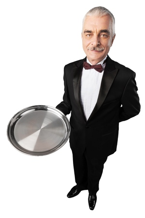 Portrait of handsome grey hair waiter standing with salver and looking at camera isolated on whiteの写真素材