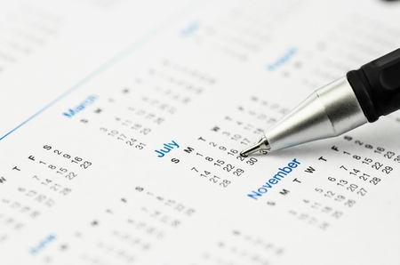 Pen Pointing at a Day in Calendarの写真素材