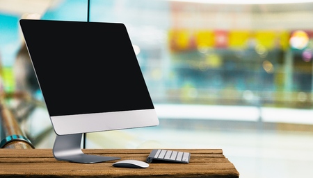 Work place concept : Mock up Blank screen computer desktop with keyboard in cafe or co-working...