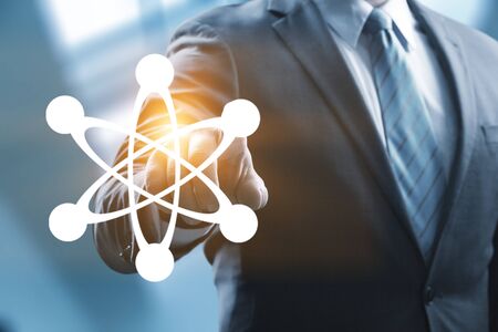 Mergers and acquisition concept with consultant touching icons of puzzle pieces representing the...