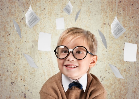 Thoughtful boy funny portrait with abstract idea clouds on chalkboardの写真素材