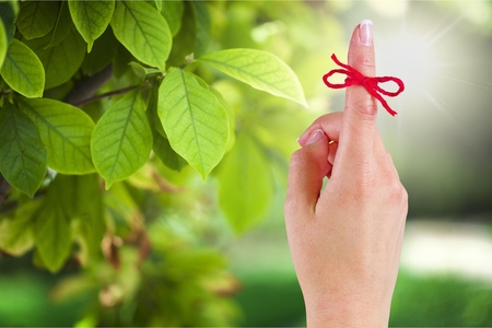 Rope bow on finger pointing  up on backgroundの写真素材