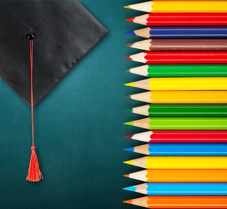 congratulations graduates background, inscription in pencil and graduate capの写真素材