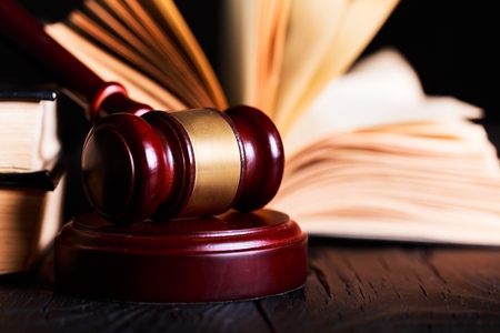 Wooden gavel and books on wooden table, law conceptの写真素材
