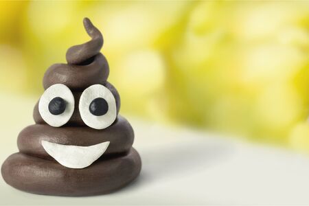 Poop emoticon on bright background. Minimal concept.