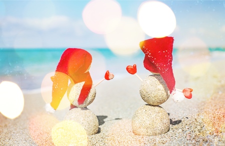 Sand Snowman on the Beach. New years holiday in hot countries concept
