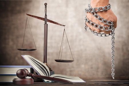 Golden scales of justice, gavel and books isolated on white