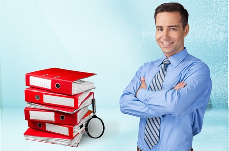 Stack of Folders with Magnifying Glassの写真素材