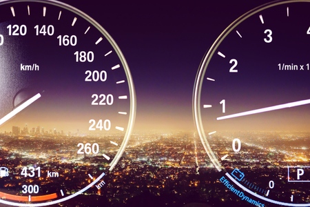 Back lit Speedometer and rev counter dashboard dials illuminated at night in automobileの写真素材