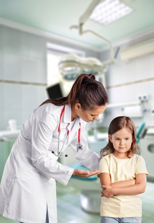 close up of doctor giving capsules of cod-liver oil to a girl at hospitalの写真素材