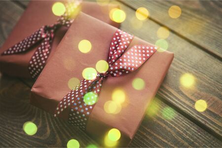 two elegant gift boxes on a wooden background