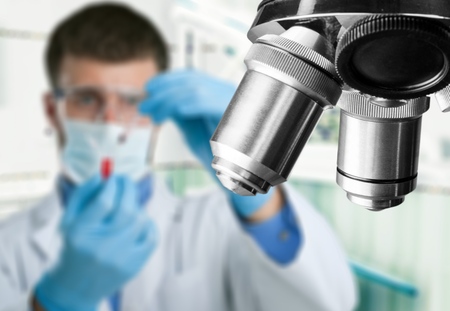 scientist hands using microscope for