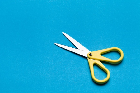 Scissor on blue background