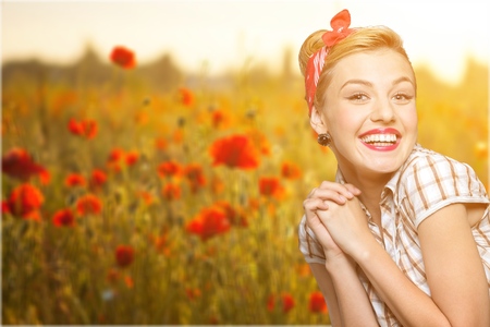 Surprised woman with open mouth. Pinup girl. Beauty woman over red polka dots background. Emotionsの写真素材