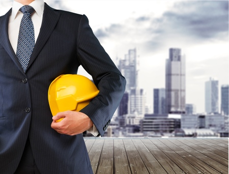 engineer yellow helmet for workers security on the background of a new high-rise apartment buildings...