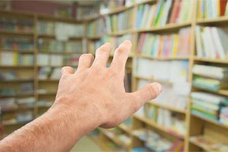 Hand reaching out from the darkの写真素材