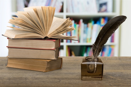 Old quill pen with inkwell and old collection bookの写真素材